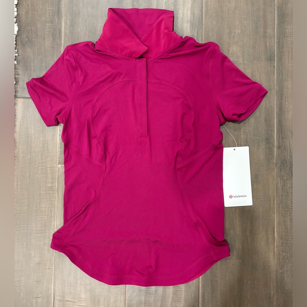Magenta/bright pink golf t-shirt from lululemon. Size 2.
